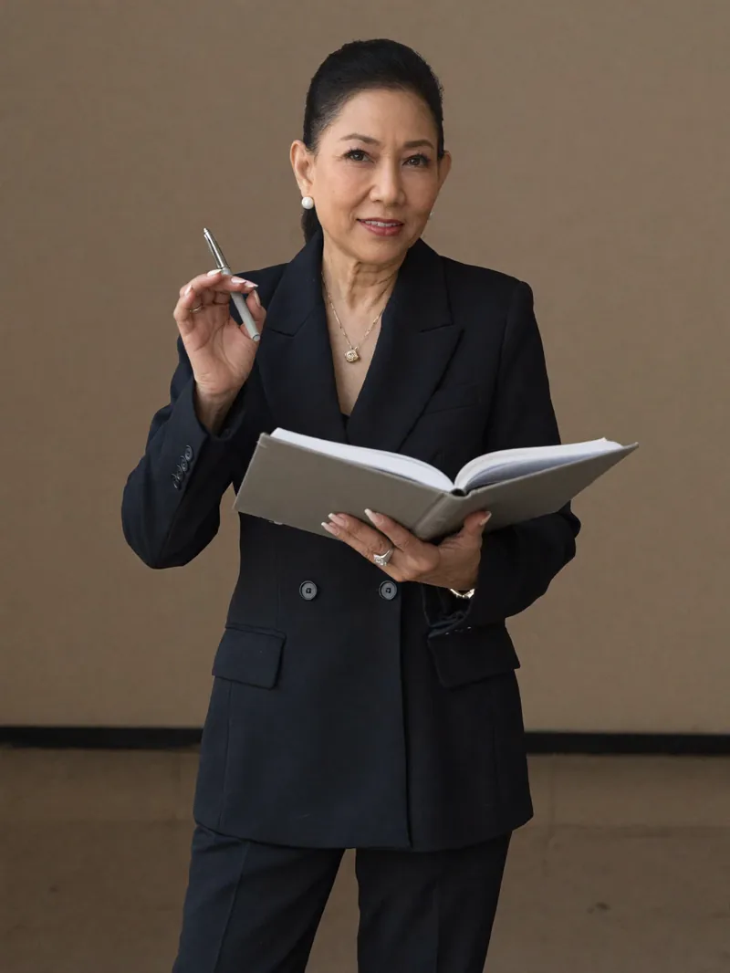 Chanida holding an open notebook and pen